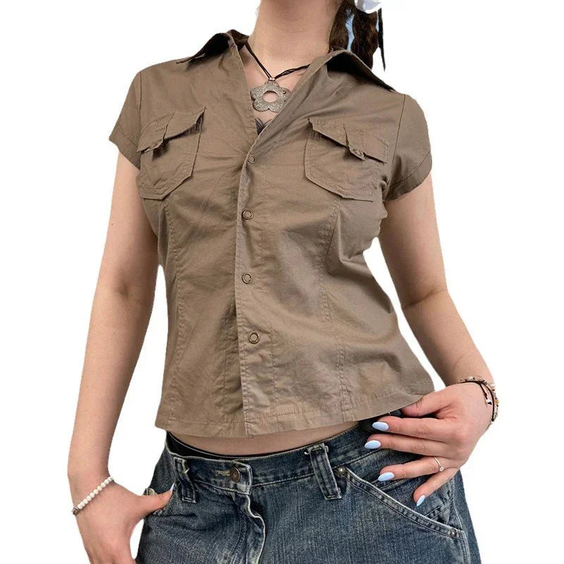 Woman wearing brown short-sleeve button-up shirt with front pockets and blue denim jeans
