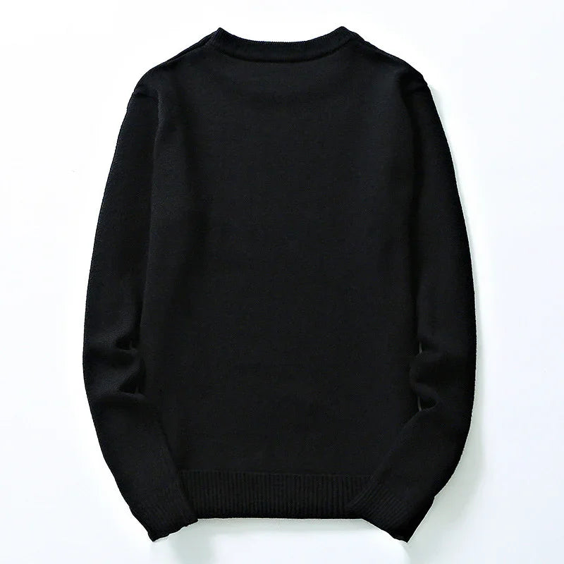 Plain black long-sleeve knitted sweater laid flat on white background
