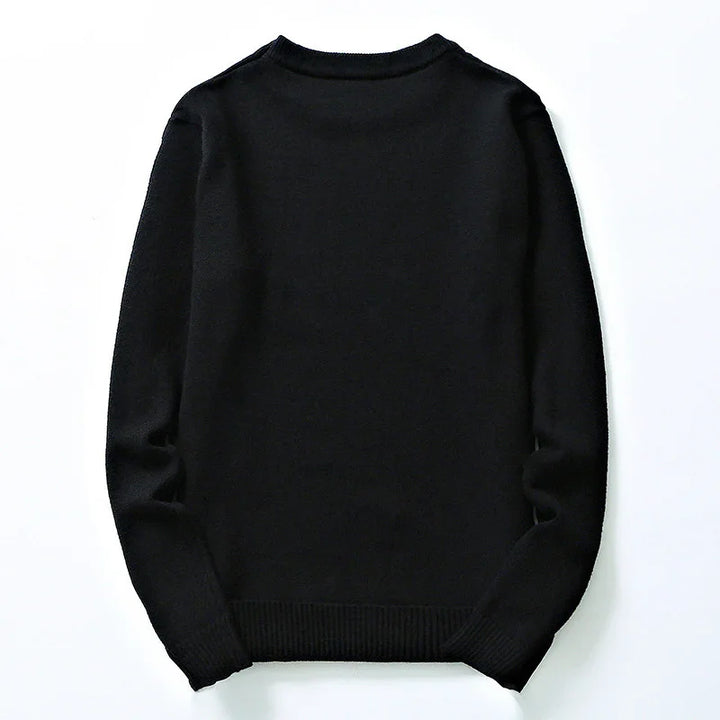 Plain black long-sleeve knitted sweater laid flat on white background