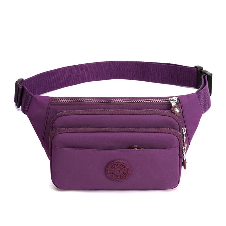 Purple waist bag with multiple zippered compartments and adjustable strap on white background