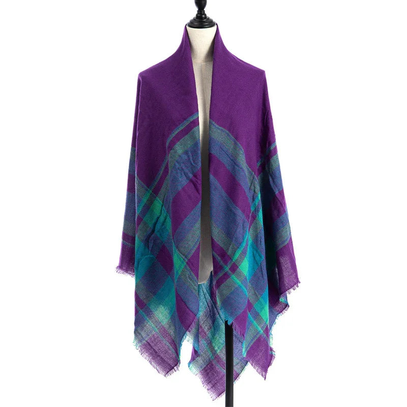 Purple and teal plaid wool shawl draped on mannequin with fringed edges