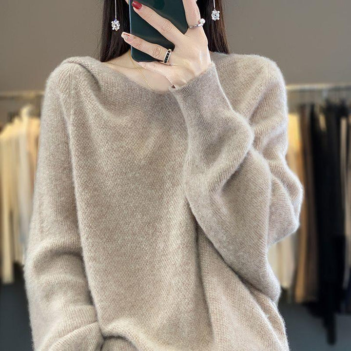 Woman wearing soft beige crew neck fuzzy sweater taking mirror selfie with smartphone