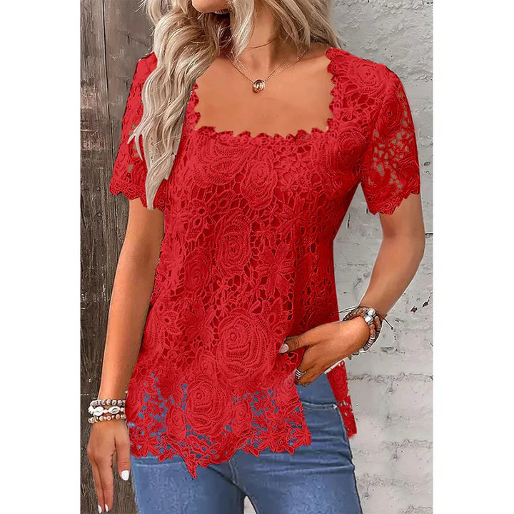 Woman wearing red floral lace short sleeve top with scalloped edges and blue jeans