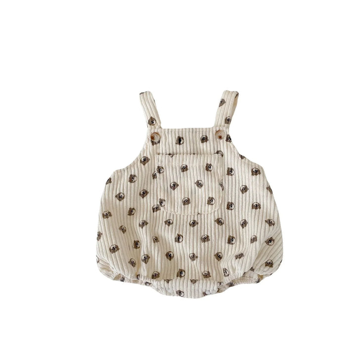 Beige baby romper with dog face print, front pocket, and buttoned shoulder straps