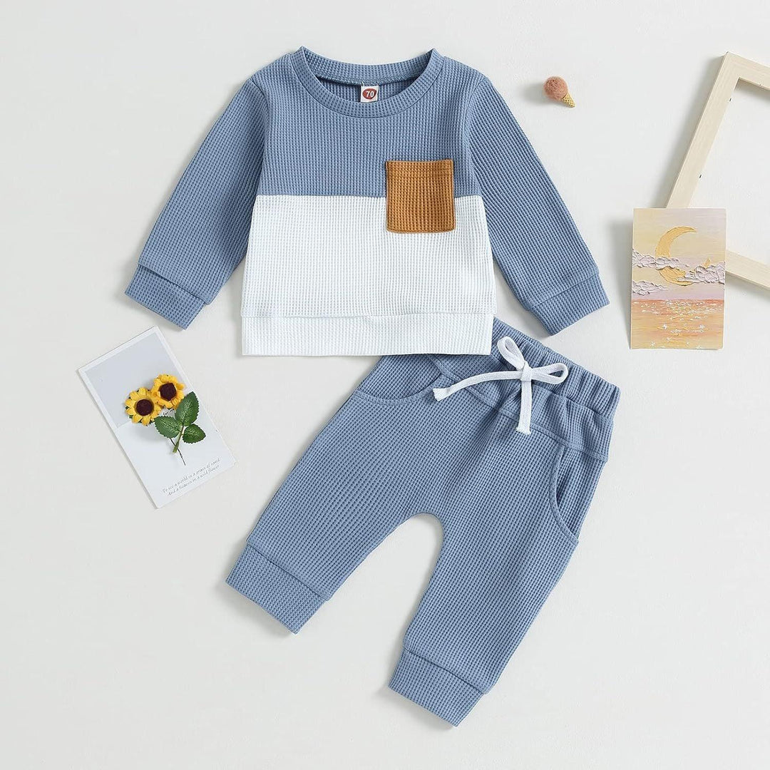Blue and white toddler waffle knit set with brown pocket and matching blue pants with drawstring