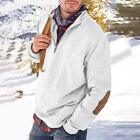 man by snowy river wearing white pullover with elbow patches and striped scarf