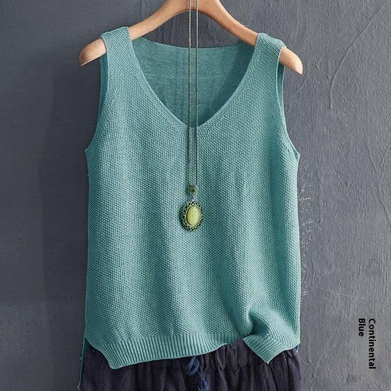 Light blue sleeveless knitted top with V-neck and pendant necklace hanging on wooden hanger