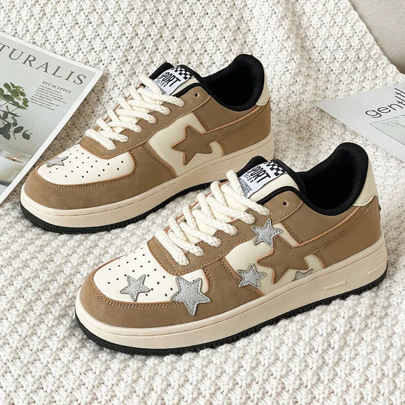 Beige and cream sneakers with star patterns on knitted white fabric next to magazines