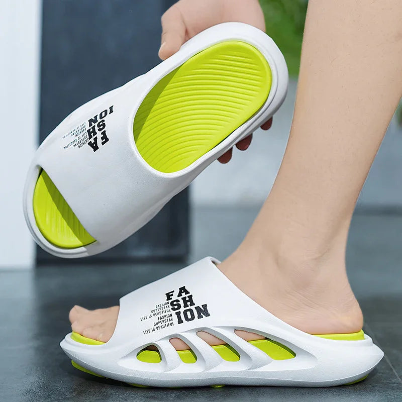 White and lime green slide sandals with FASHION text, worn on foot indoors on gray floor