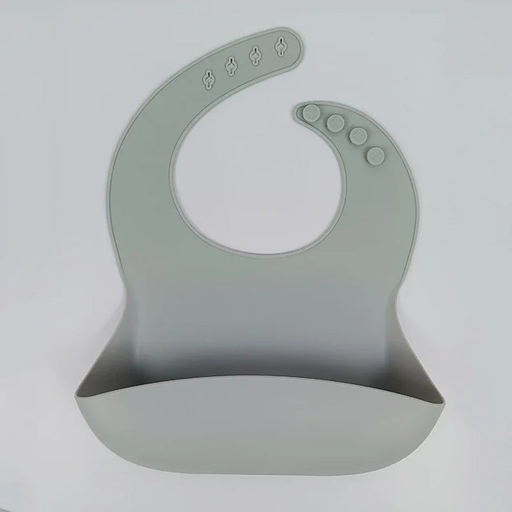 Gray silicone baby bib with adjustable snap buttons and food-catching pocket