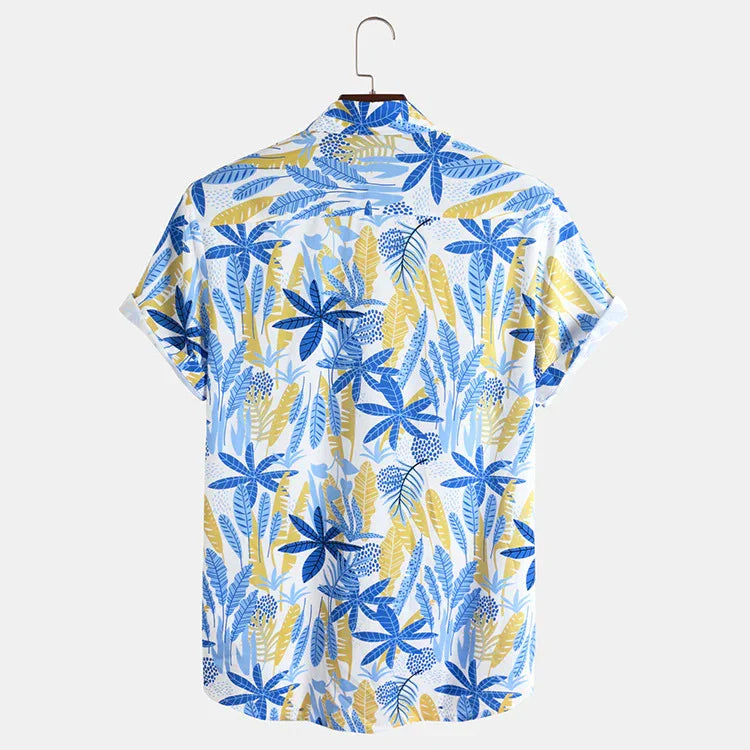Back view of short sleeve tropical shirt with blue and yellow leaf pattern on white background hanging on wooden hanger