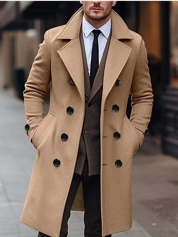 Man wearing stylish camel double-breasted wool coat over brown blazer and black tie on city street