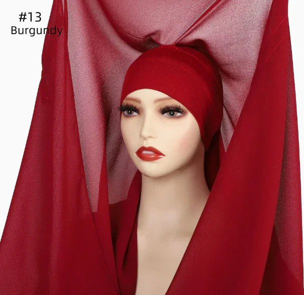 Mannequin headwear in burgundy with matching veil fabric draped around the face