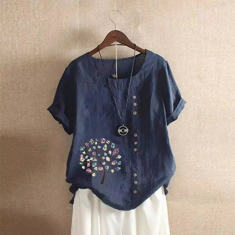 navy blue short sleeve blouse with asymmetrical buttons and colorful tree print on front