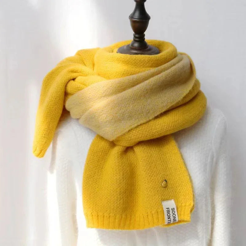 Soft yellow ombre knit scarf wrapped on mannequin over white sweater