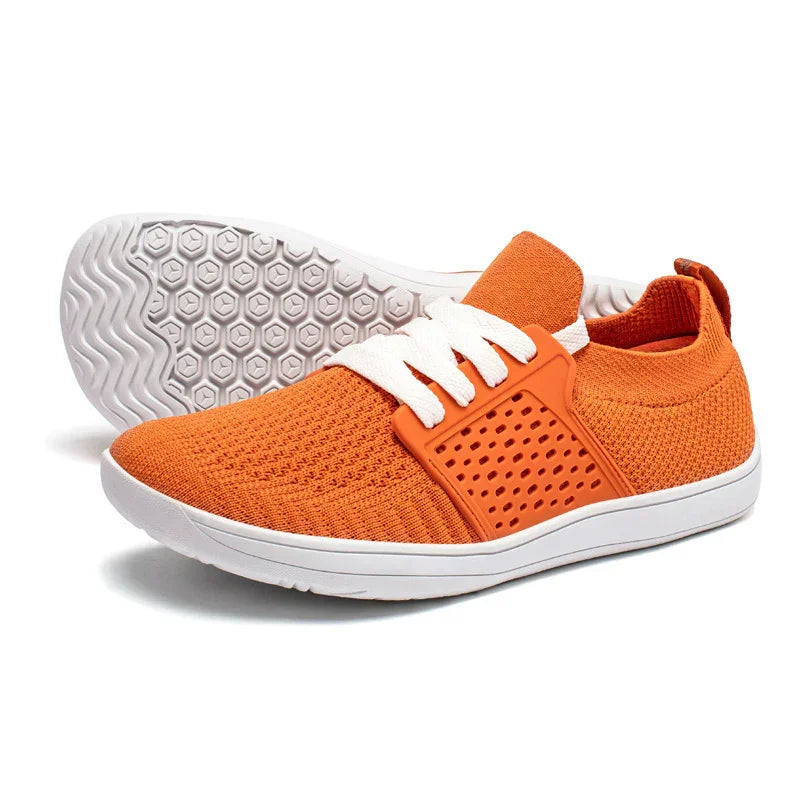 Orange knit athletic shoes with white soles and laces, featuring breathable perforated side panel