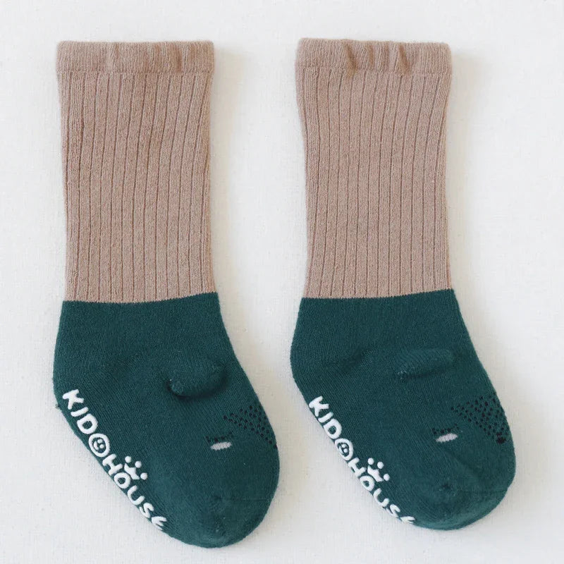 Pair of beige and dark green ribbed kids socks with Kidolhouse logo on white background