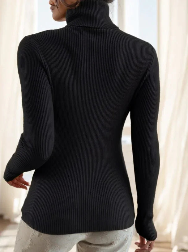 Back view of woman wearing black ribbed turtleneck sweater indoors with light curtains