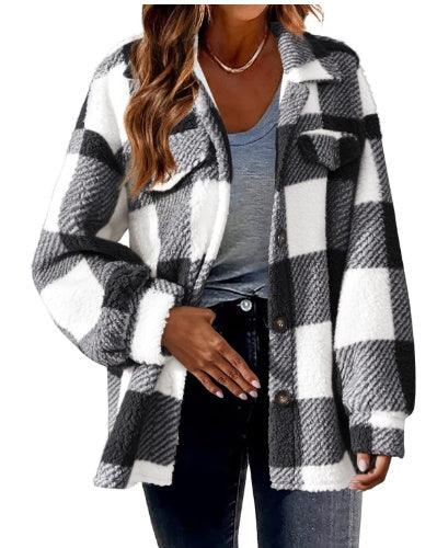 Woman wearing black and white plaid sherpa jacket over gray t-shirt and black jeans