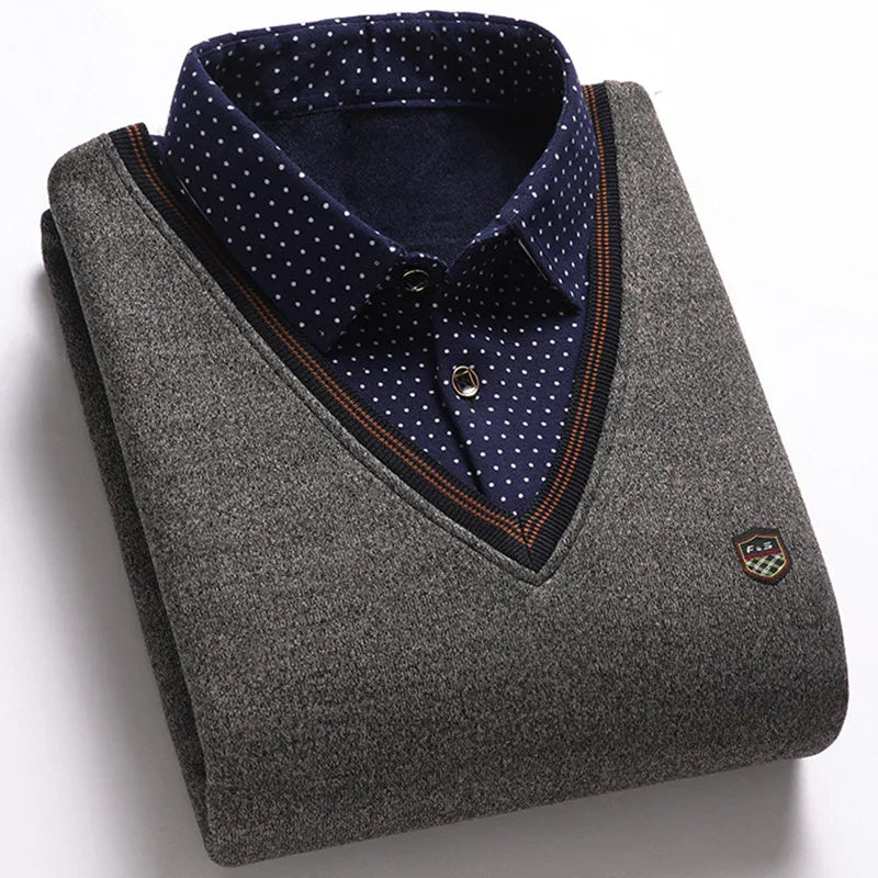 Folded gray V-neck sweater with navy blue polka dot shirt collar and emblem detail
