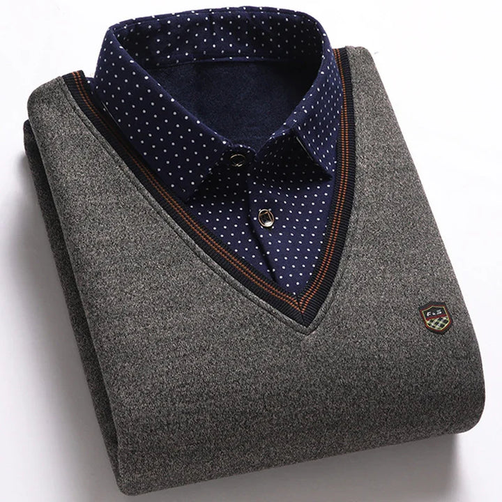 Folded gray V-neck sweater with navy blue polka dot shirt collar and emblem detail