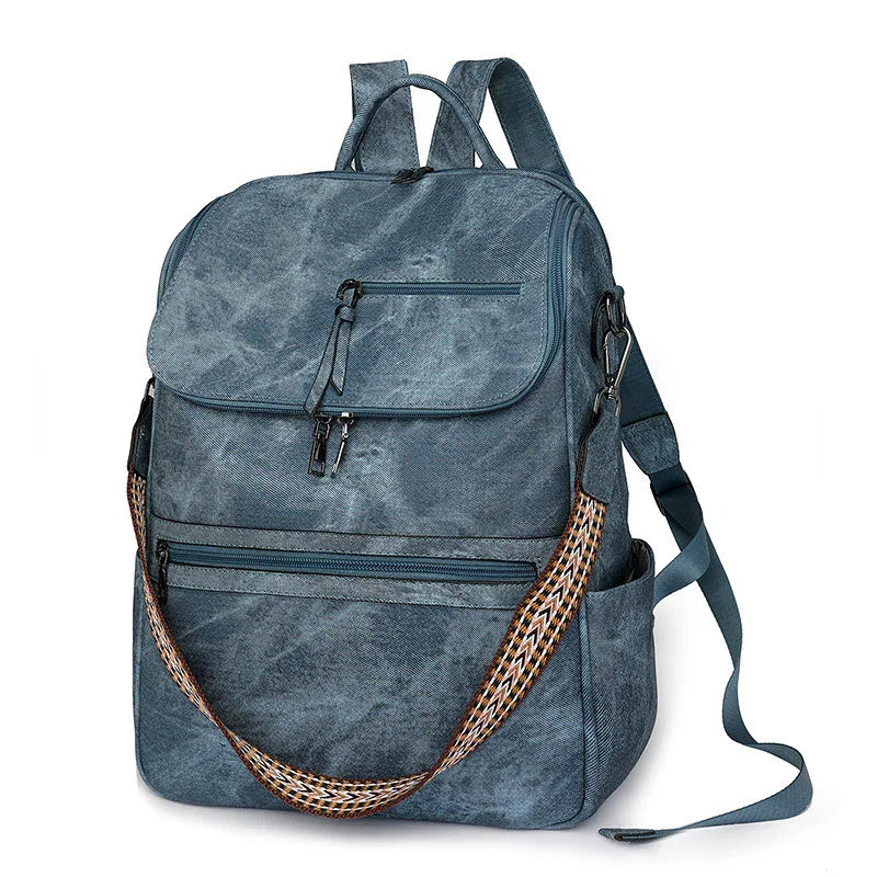 blue canvas backpack with front zipper pockets and patterned shoulder strap