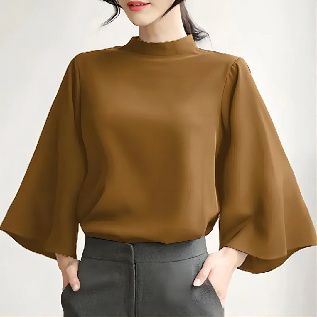Woman wearing brown bell sleeve blouse paired with high-waisted black pants