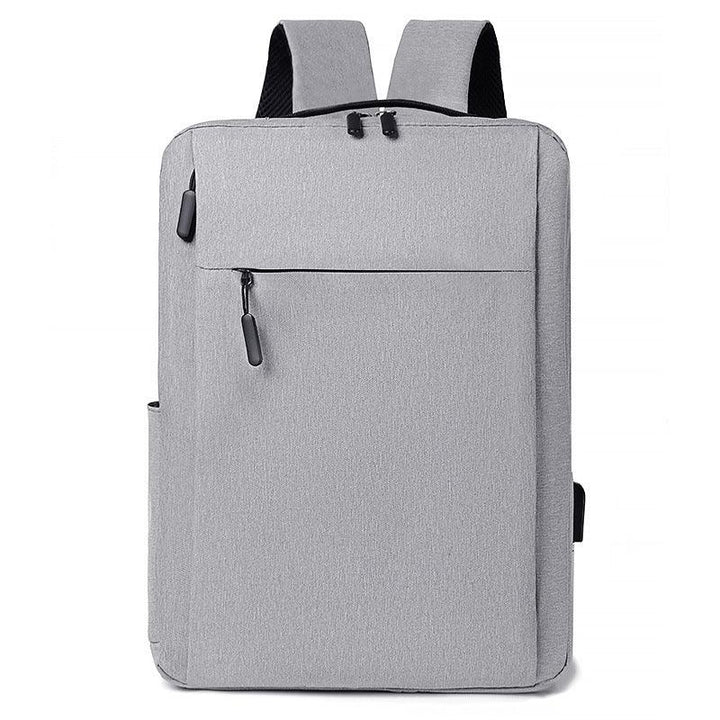 Minimalist light gray rectangular backpack with front zipper pocket and padded shoulder straps