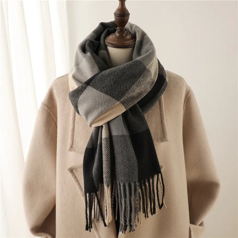 Beige coat on mannequin with black and gray checkered scarf with fringes in soft fabric