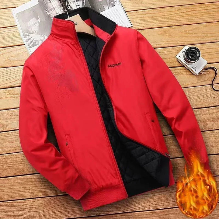 Red Mupusen quilted warm jacket on wooden surface with camera and magazines nearby