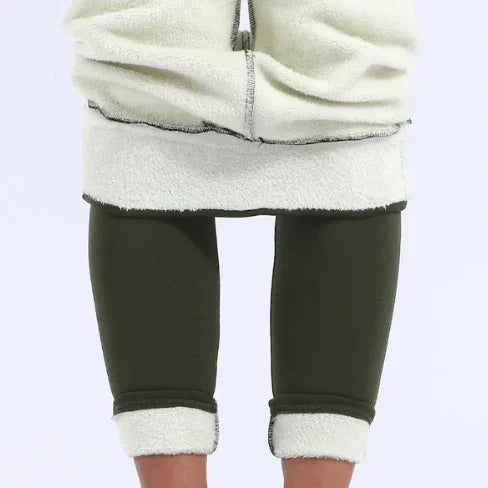 Person wearing cream fleece jacket and dark green fleece-lined leggings rolled up at ankles