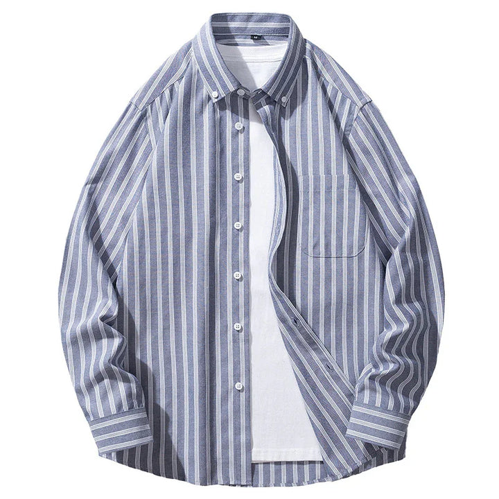 Blue and white vertical striped button-up shirt layered over plain white t-shirt