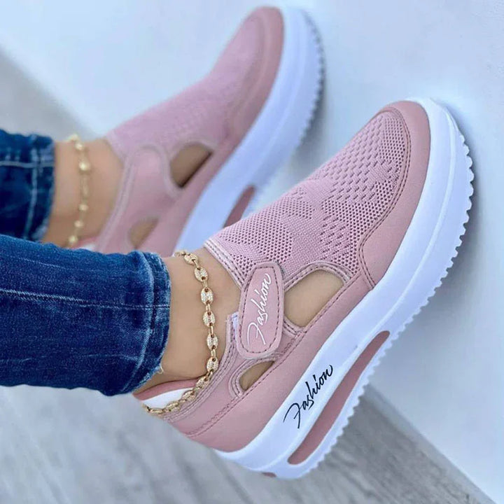 Pink mesh platform sneakers with white soles labeled Fashion, worn with blue jeans and anklet