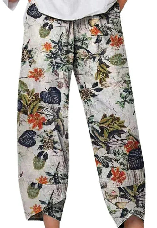 light-colored casual pants with vibrant tropical floral print in green, orange, and black
