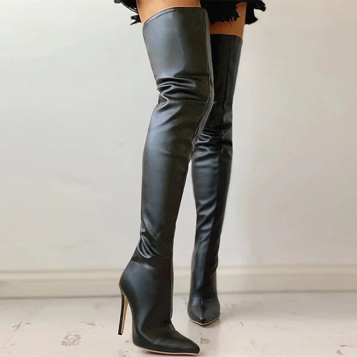 Black leather thigh-high stiletto boots with pointed toes on a marble floor