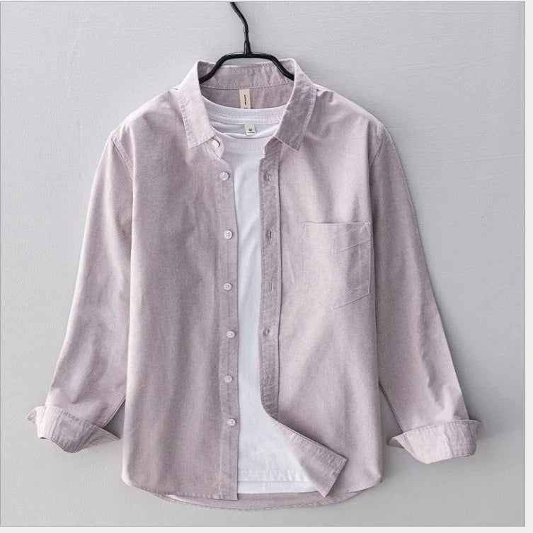 Light purple corduroy shirt with front pocket layered over white t-shirt on hanger