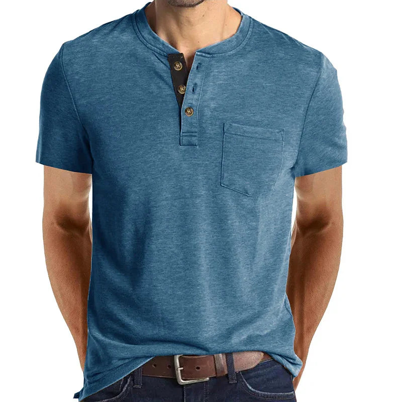 Men's blue short sleeve henley shirt with chest pocket, button placket, worn with brown belt and jeans