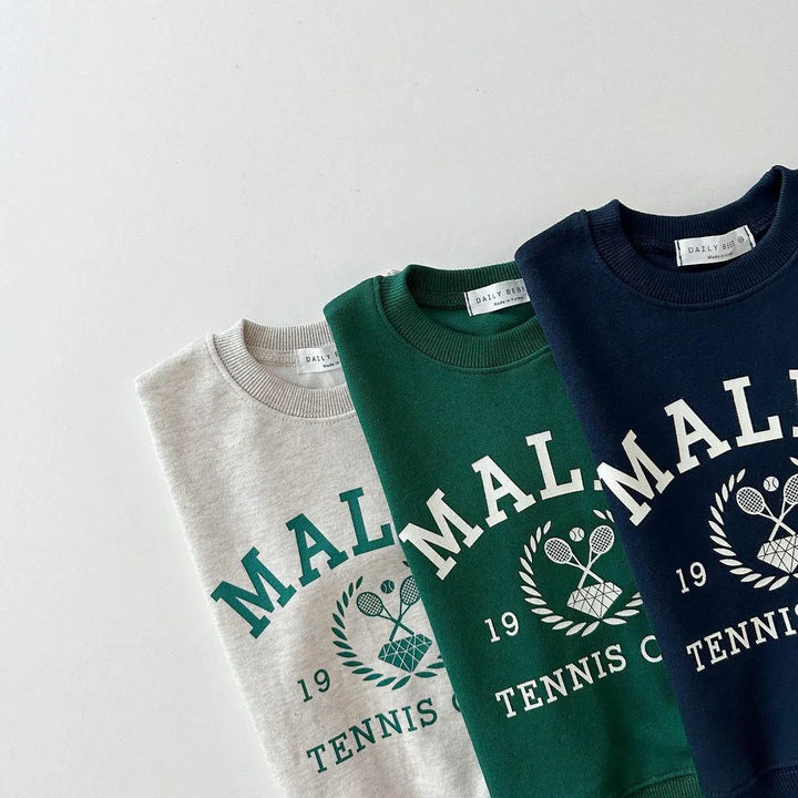 Folded sweatshirts in beige, green, and navy with Malden Tennis Club print and crossed rackets