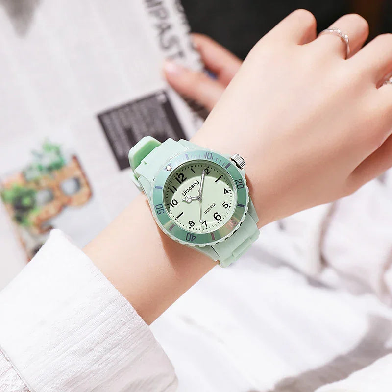 mint green Uitzang quartz wristwatch with silicone strap on a woman's wrist