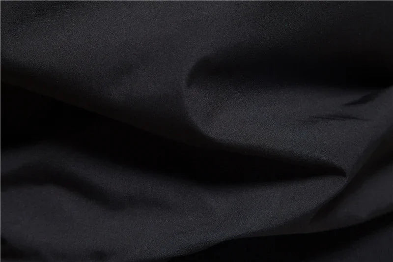 Close-up of smooth black fabric with soft folds and subtle texture