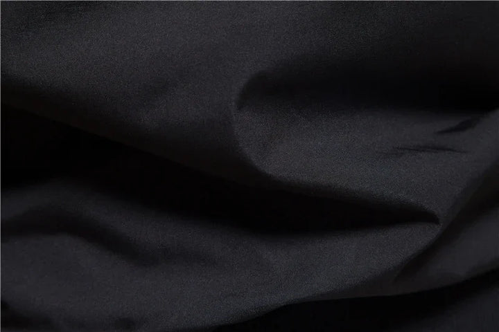 Close-up of smooth black fabric with soft folds and subtle texture