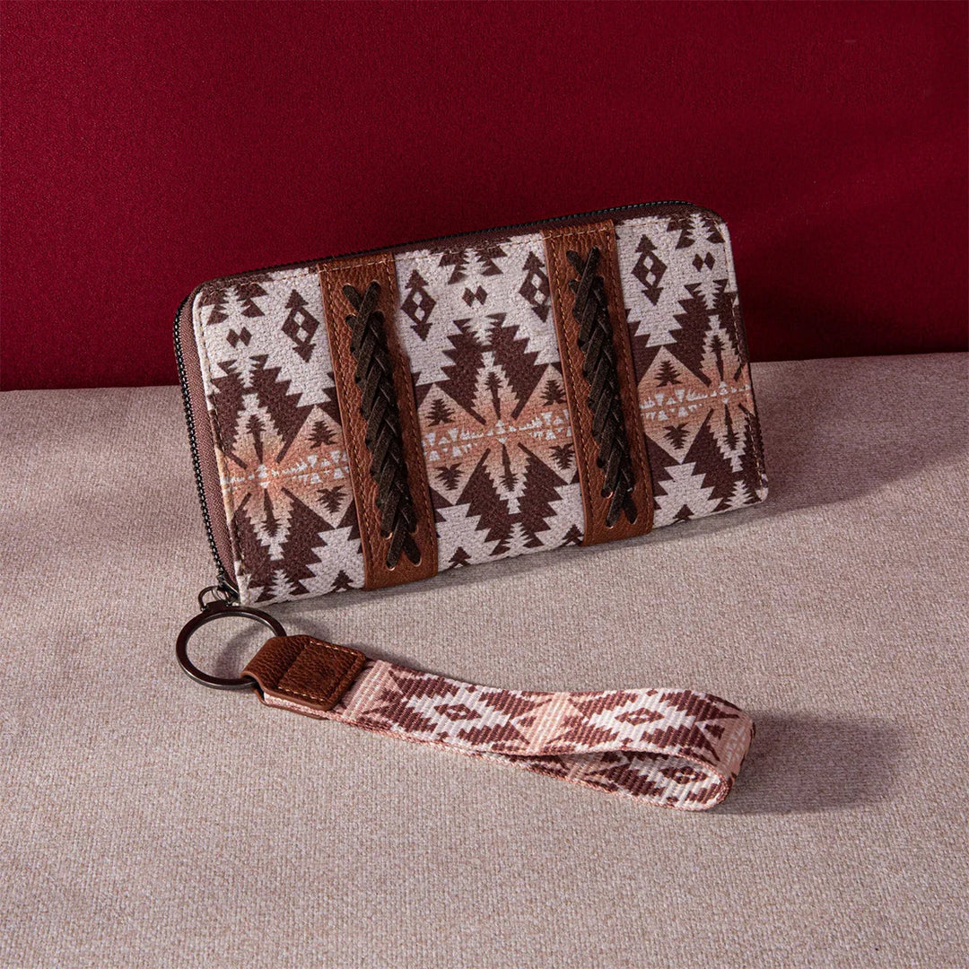 Brown and beige southwestern patterned wristlet wallet with leather braided accents on beige fabric