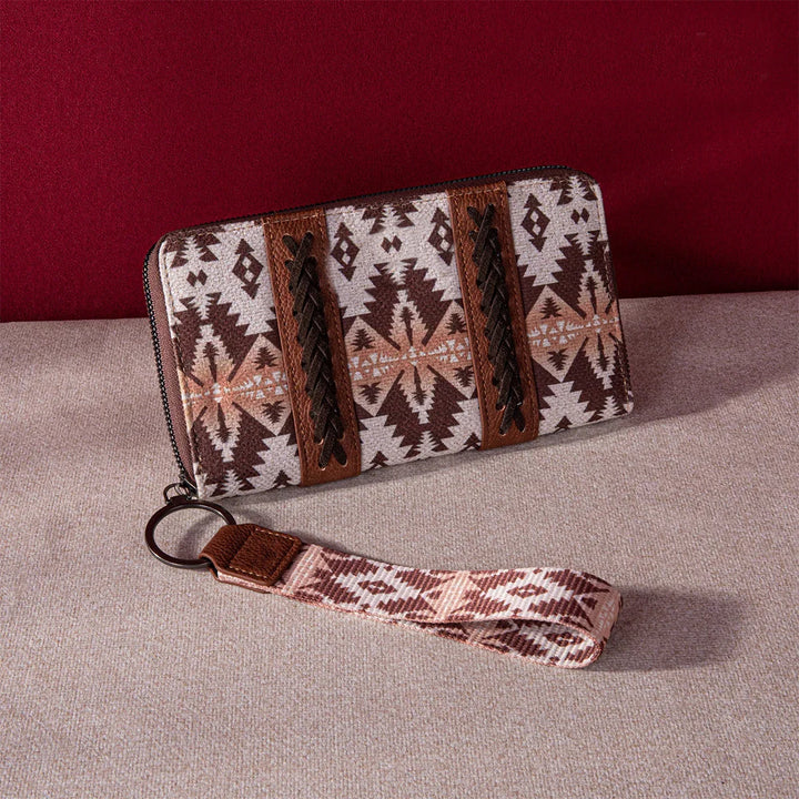 Brown and beige southwestern patterned wristlet wallet with leather braided accents on beige fabric