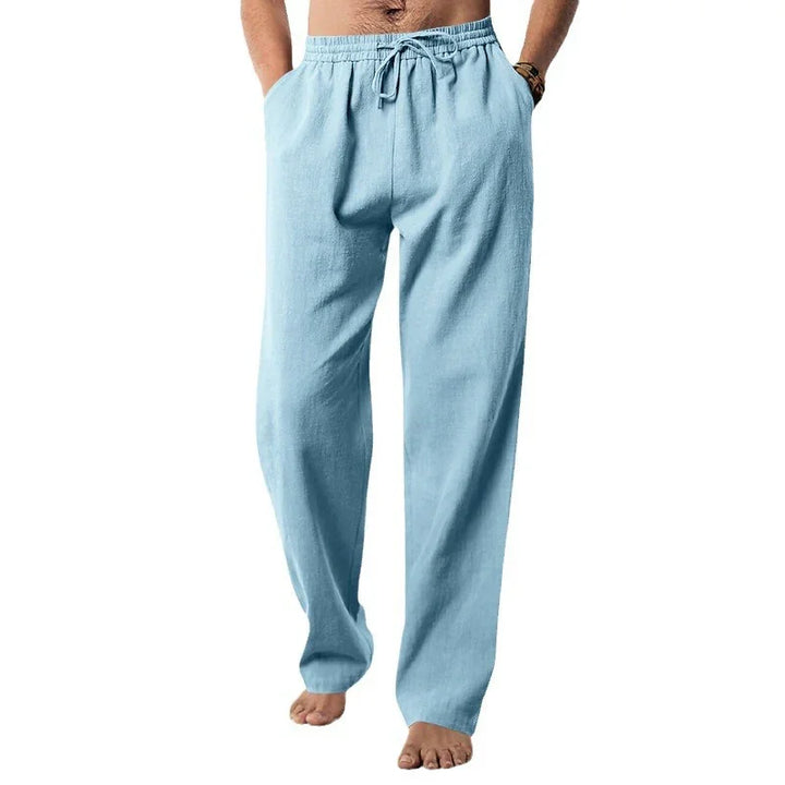 Light blue men's casual linen pants with drawstring waist, relaxed fit, barefoot model