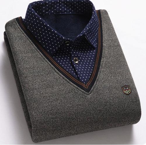 Folded grey V-neck sweater layered over navy blue polka dot shirt with button detail