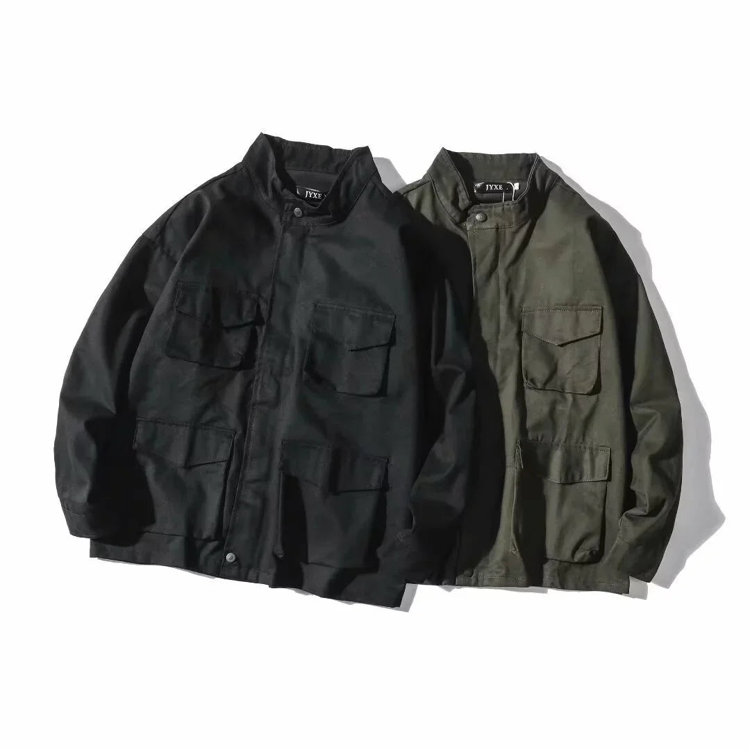 Black and olive green utility jackets with stand collars and multiple front pockets on white background