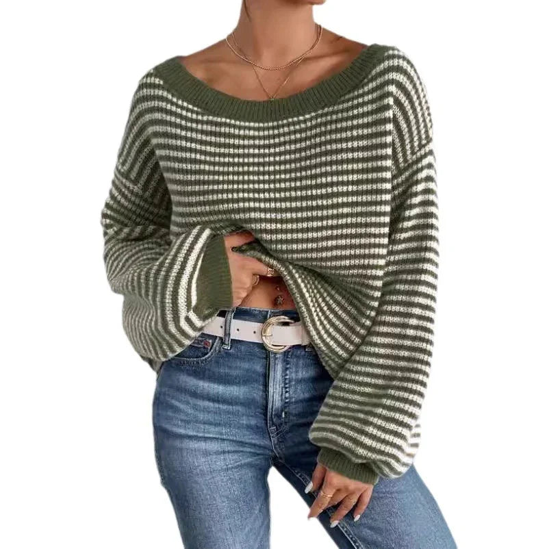 Woman wearing green and white striped loose knit sweater with blue jeans and white belt