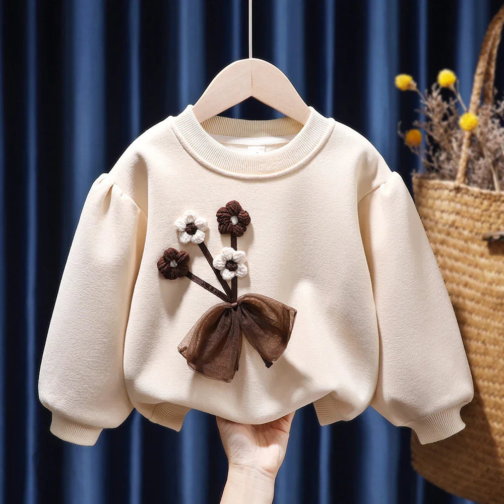 Cream toddler sweater with puff sleeves and brown and white flower applique with bow