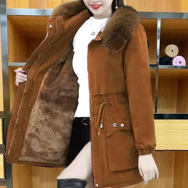 Woman wearing brown fur-lined coat with fur collar and large front pockets in modern room