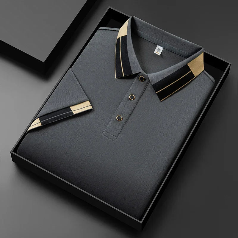 Folded dark gray polo shirt with black and beige striped collar and sleeve detail in black gift box